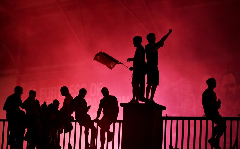 Liverpool fans celebrate their first Premier League title in 30 years outside Anfield stadium. EPA