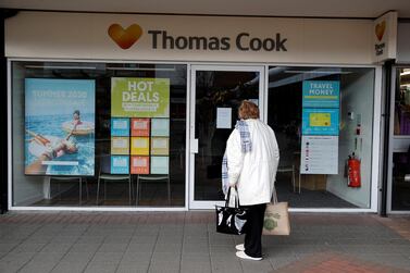 A woman stands outside a closed Thomas Cook store near Manchester in the UK in October last year. The company's new online-only offering employs just 50 staff. Reuters