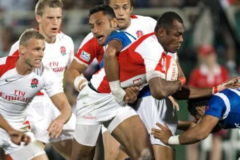 Dubai - December 5, 2009 - Samoa's Lolo Lui tackles England's Isoa Damudamu during their Cup Semi Final match of the IRB Sevens World Series XI tournament in Dubai December 5, 2009. Samoa defeated England 28-19. (Photo by Jeff Topping/The National) *** Local Caption ***  JT030-1205-RUGBY SEVENS_F8Q4735.jpg