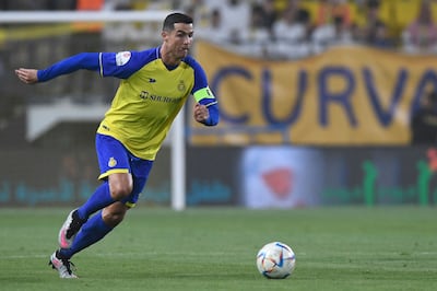 Cristiano Ronaldo runs with the ball during the Saudi Pro League match between Al Nassr and Al Raed in Riyadh. AFP