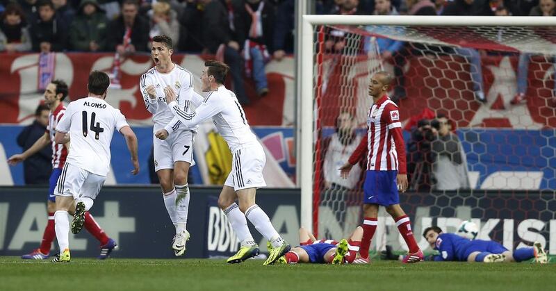 Real's Cristiano Ronaldo, second left, celebrates his goal with Gareth Bale, centre, in the Primera Liga derby on Sunday, March 2, 2014. Andres Kudacki / AP Photo