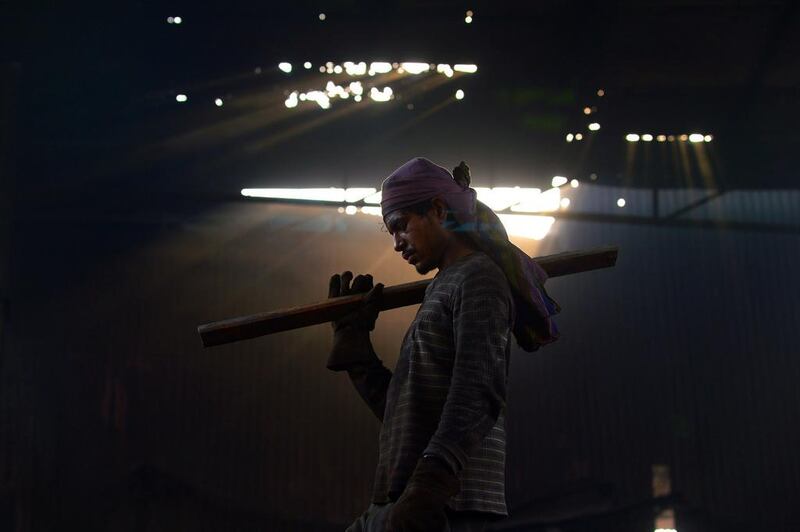 A Pakistani worker takes a break at a steel mill in an industrial area of Lahore, Pakistan. Arif Ali / AFP
