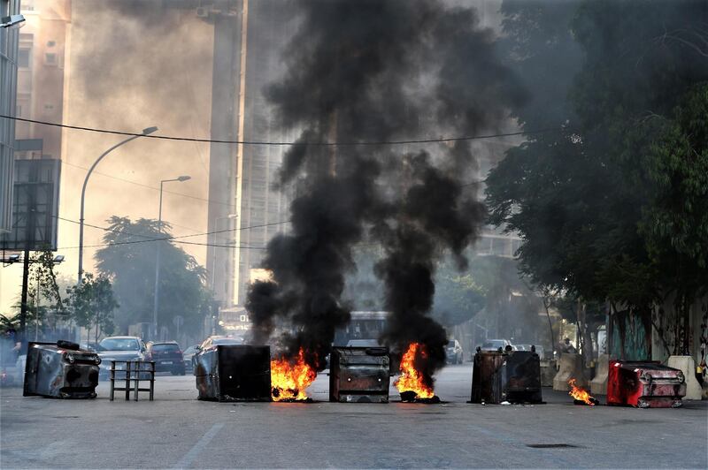 Anti-Government protestors set garbage bins on fire and block the majority of the main roads. EPA