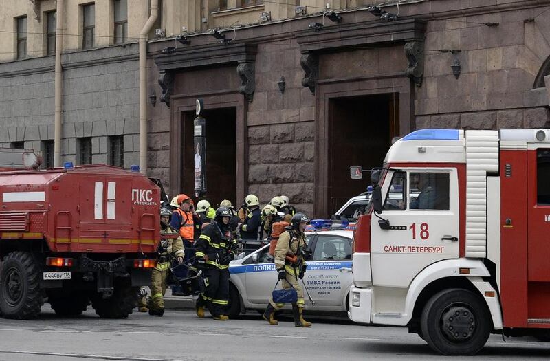 Emergency services personnel walk at the entrance to the Technological Institute metro station in St Petersburg. Olga Maltseva / AFP