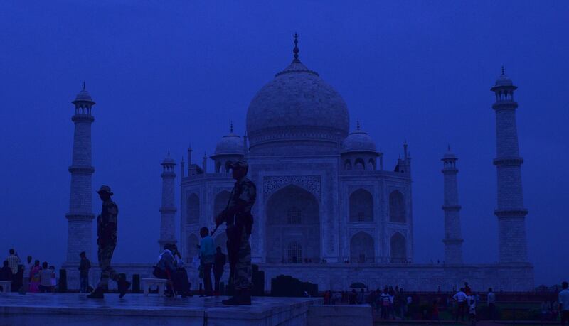 Members of the security forces guard the Taj Mahal after sunset in Agra, India. EPA