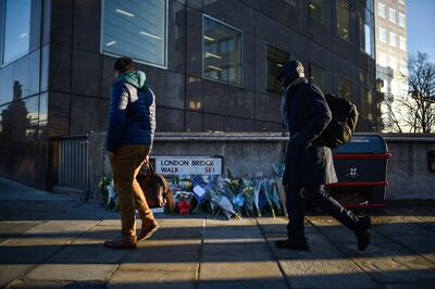 LONDON, ENGLAND - DECEMBER 02: Floral tributes are left for Jack Merritt and Saskia Jones, who were killed in a terror attack, on December 2, 2019 in London, England. Usman Khan, a 28 year old former prisoner convicted of terrorism offences, killed two people in Fishmongers' Hall at the North end of London Bridge on Friday, November 29, before continuing his attack on the bridge. Mr Khan was restrained and disarmed by members of the public before being shot by armed police. (Photo by Peter Summers/Getty Images)