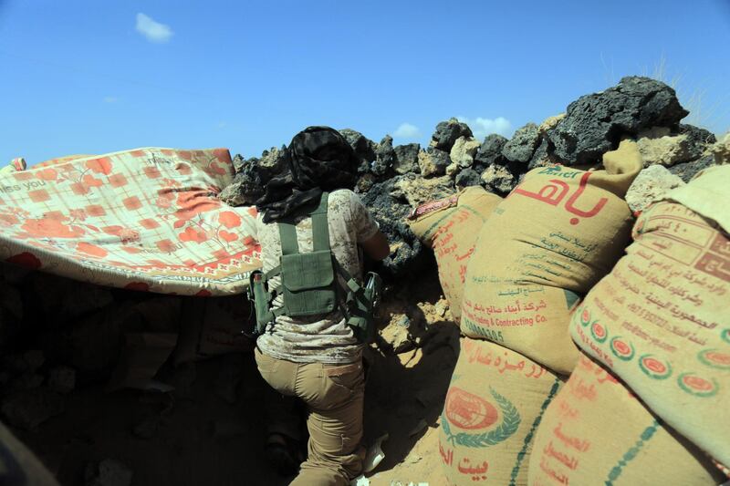 A fighter loyal to Yemen's Saudi-backed government takes position during the fight against Houthi militiamen in the northeastern province of Marib. EPA