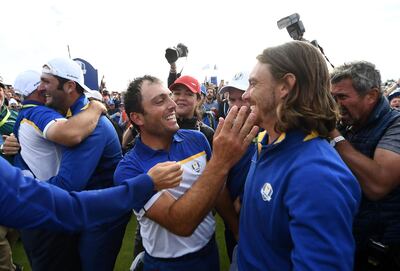 TOPSHOT - Europe's Italian golfer Francesco Molinari (C) celebrates with Europe's English golfer Tommy Fleetwood after victory in during his singles match on the third day of the 42nd Ryder Cup at Le Golf National Course at Saint-Quentin-en-Yvelines, south-west of Paris on September 30, 2018.  / AFP / FRANCK FIFE
