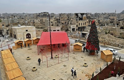 Workers set up a Christmas tree at al-Hatab square, one of the oldest in Syria's northern city of Aleppo. AFP