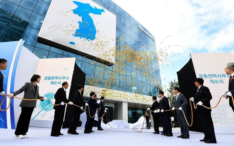 FILE - In this Sept. 14, 2018, file photo, South Korea's Unification Minister Cho Myoung-gyon, center left, and Ri Son Gwon, chairman of the North's Committee for the Peaceful Reunification, center right, attend at an opening ceremony for two Koreas' first liaison office in Kaesong, North Korea. North Korea abruptly withdrew its staff from an inter-Korean liaison office in the North on Friday, Seoul officials said on Friday, March 22, 2019. (Korea Pool/Yonhap via AP, File)