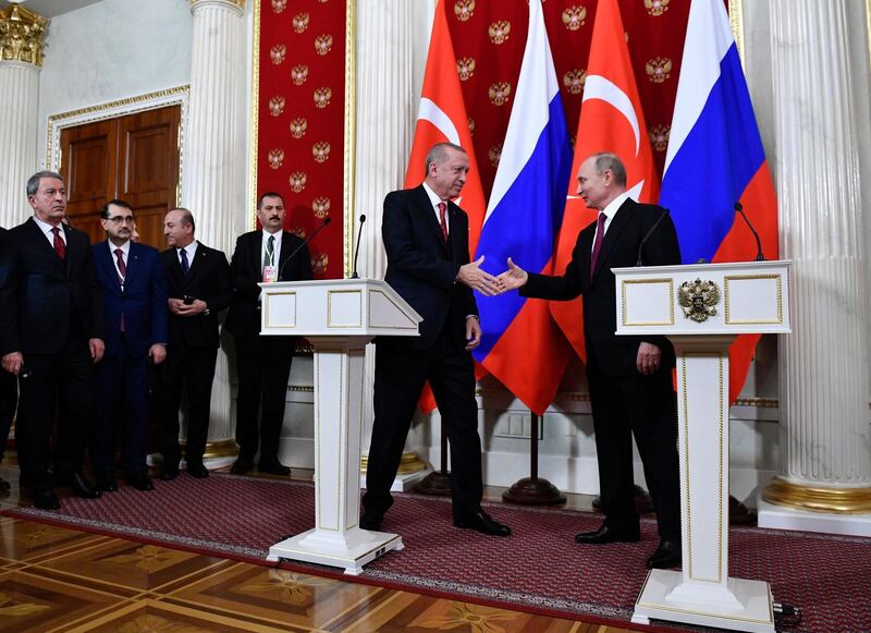 Russian President Vladimir Putin, right, and Turkey's President Recep Tayyip Erdogan shake hands after their joint news conference following the talks in the Kremlin in Moscow, Russia, Wednesday, Jan. 23, 2019. Russia and Turkey are jockeying for clout in Syria as the U.S. plans to withdraw its troops from the country. (Alexander Nemenov/Pool Photo via AP)