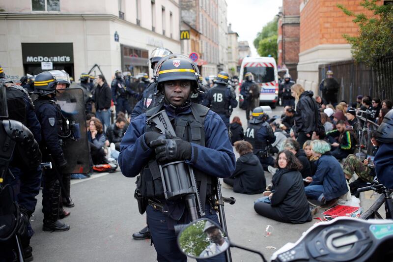 Riot police detain protesters after clashes broke out with activists. AP/Francois Mori
