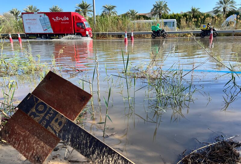 A lorry navigates a flooded section of Al Qudra Road after heavy rain in Dubai. Chris Whiteoak / The National
