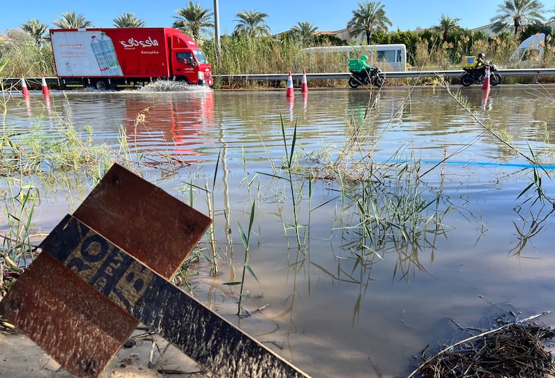 A lorry navigates a flooded section of Al Qudra Road after heavy rain in Dubai. Chris Whiteoak / The National