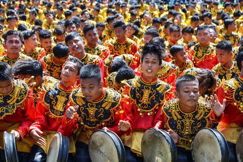 Performers take part in the Rapa'i Geleng dance, using a traditional tambourine, to celebrate Indonesia's 74th Independence Day in Blang Pidie, Aceh province.  AFP