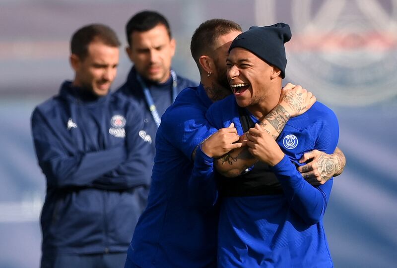 Paris Saint-Germain's Spanish defender Sergio Ramos (L) jokes with Paris Saint-Germain's French forward Kylian Mbappe during a training session at the club's Camp des Loges training ground in Saint-Germain-en-Laye, near Paris on October 10, 2022, on the eve of their UEFA Champions League first round Group H football match against Benfica.  (Photo by FRANCK FIFE  /  AFP)
