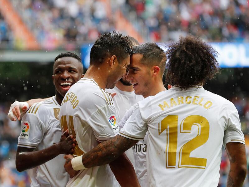 Real Madrid's Casemiro, second left, celebrates with teammates after scoring his side's third goal. AP Photo