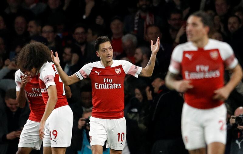 Soccer Football - Premier League - Arsenal v Leicester City - Emirates Stadium, London, Britain - October 22, 2018   Arsenal's Mesut Ozil and team mates celebrate their third goal    REUTERS/Peter Nicholls    EDITORIAL USE ONLY. No use with unauthorized audio, video, data, fixture lists, club/league logos or "live" services. Online in-match use limited to 75 images, no video emulation. No use in betting, games or single club/league/player publications.  Please contact your account representative for further details.