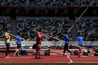 Olympics - Tokyo 2020 Olympic Games Test Event - Athletics - Olympic Stadium, Tokyo, Japan - May 9, 2021. Athletes are seen with pole vaults before competing in their event at the morning session of the Athletics test event. REUTERS/Issei Kato