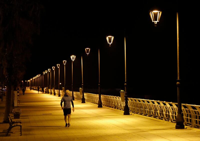 A Lebanese man walks on a mostly empty corniche, or waterfront promenade, along the Mediterranean Sea, as the country's top security council and the government ordered a lockdown over the spread of coronavirus in Beirut, Lebanon, Monday, March 16, 2020. For most people, the new coronavirus causes only mild or moderate symptoms, such as fever and cough. For some, especially older adults and people with existing health problems, it can cause more severe illness, including pneumonia.(AP Photo/Hussein Malla)