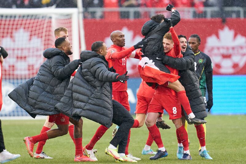 Canada players celebrate after the final whistle having sealed qualification for the 2022 World Cup. AFP