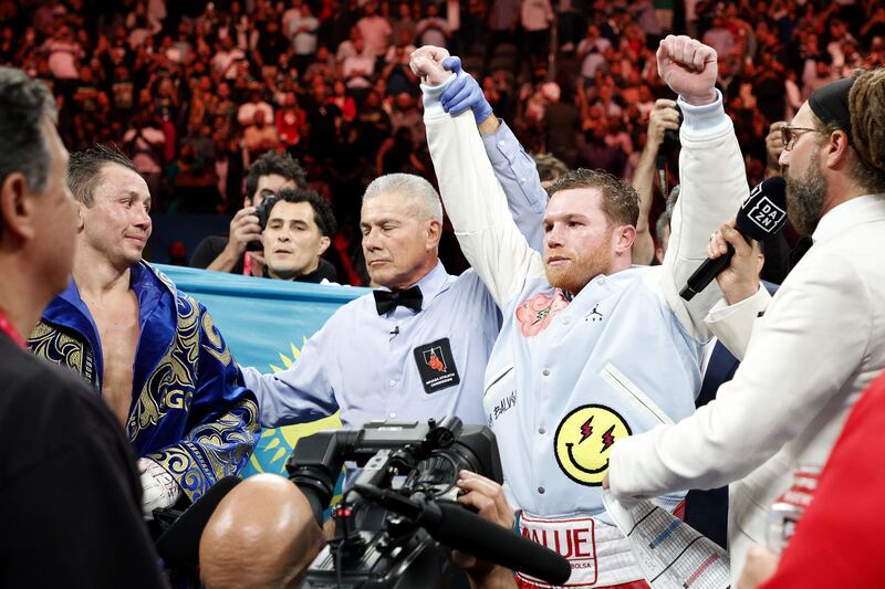 Saul Alvarez has his arm raised in victory after defeating Gennady Golovkin. AFP