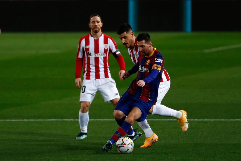 Barcelona's Lionel Messi is challenged by Athletic Bilbao's Yuri Berchiche. AP