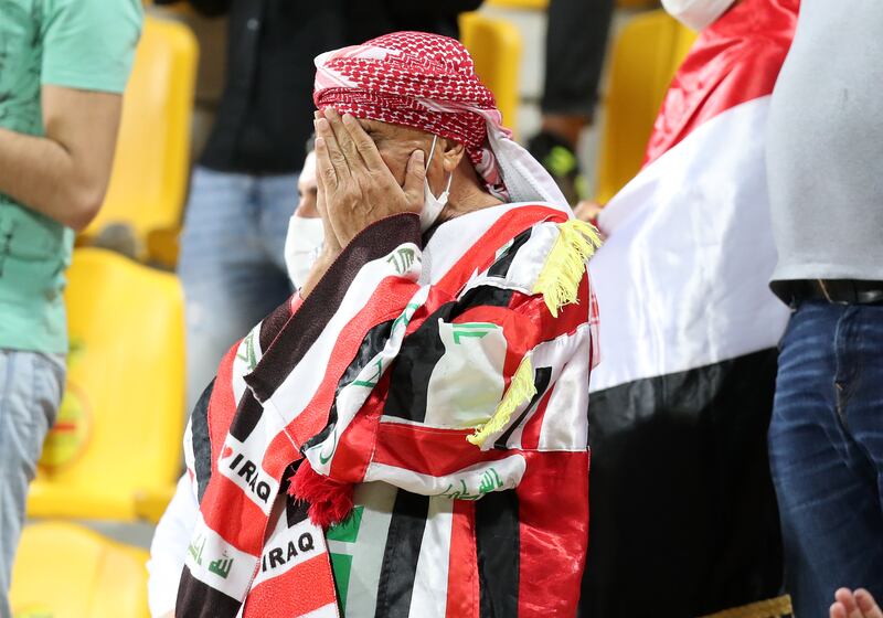 I can't watch ... it's all too much for this Iraq fan at the Zabeel Stadium. Chris Whiteoak / The National