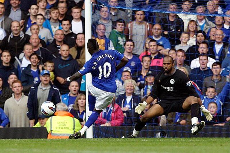 Everton's new signing Royston Drenthe curls a shot past the Wigan goalkeeper deep into injury time to complete Everton's win. It was his first goal in English football.

Jon Super / AP Photo