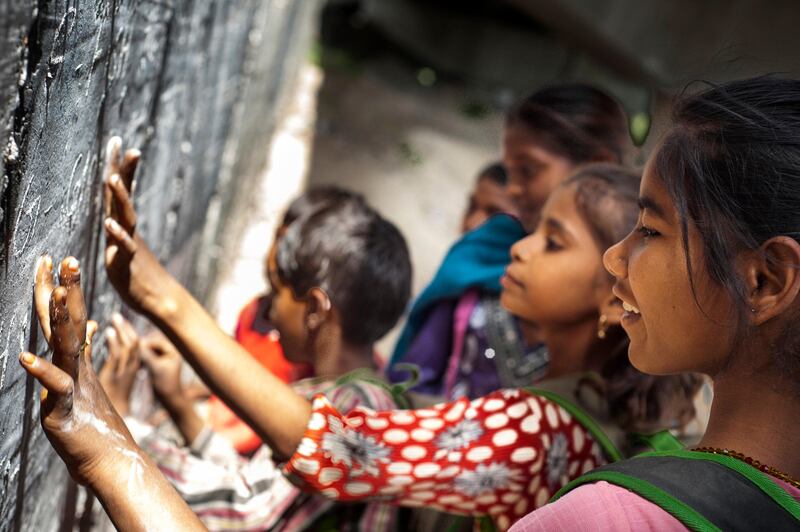 8th April 2013, Shakarpur, New Delhi, India.  Savitha Kumari (12) erases words on the blackboard after class at a makeshift school under a metro bridge near the Yamuna Bank Metro station in Shakarpur, New Delhi, India on the 8th April 2013. 

Rajesh Kumar Sharma (40), started this makeshift school a year ago. Five days a week, he takes out two hours to teach when his younger brother replaces him at his general store in Shakarpur. His students are children of labourers, rickshaw-pullers and farm workers. This is the 3rd site he has used to teach under privileged children in the city, he began in 1997 fifteen years ago. 

PHOTOGRAPH BY AND COPYRIGHT OF SIMON DE TREY-WHITE

+ 91 98103 99809
+ 91 11 435 06980
+44 07966 405896
+44 1963 220 745
email: simon@simondetreywhite.com