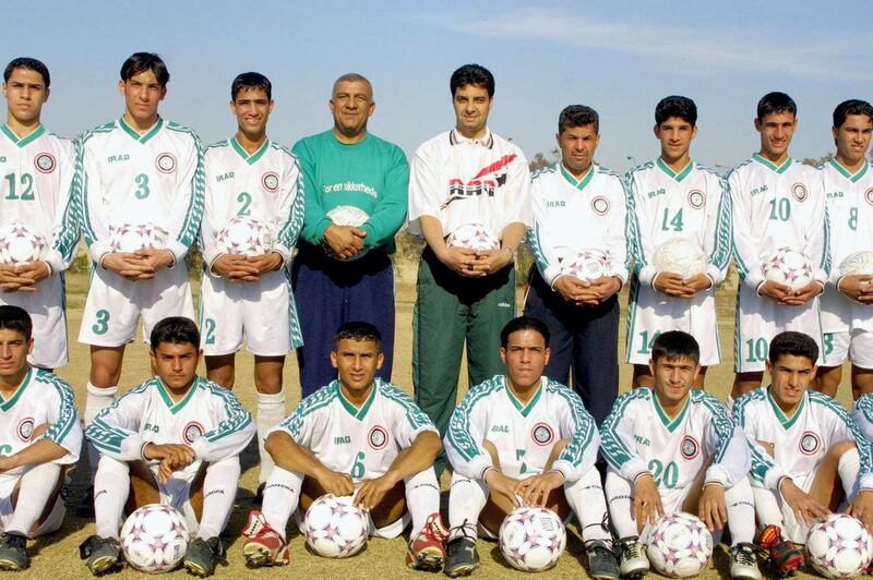 Iraqi former soccer player Ahmed Rhadi (Standing C), coach of Iraq's under-17 national soccer team, poses for a picture with his team and assistants prior to a training session 09 February 2002 in Baghdad. Rhadi played with the Iraqi team during World Cup 1986 which took place in Mexico, and scored a goal during the Group B first round match against Belgium, who beat Iraq 2-1 at Bombonera stadium.  AFP PHOTO/ramzi HAIDAR (Photo by RAMZI HAIDAR / AFP)