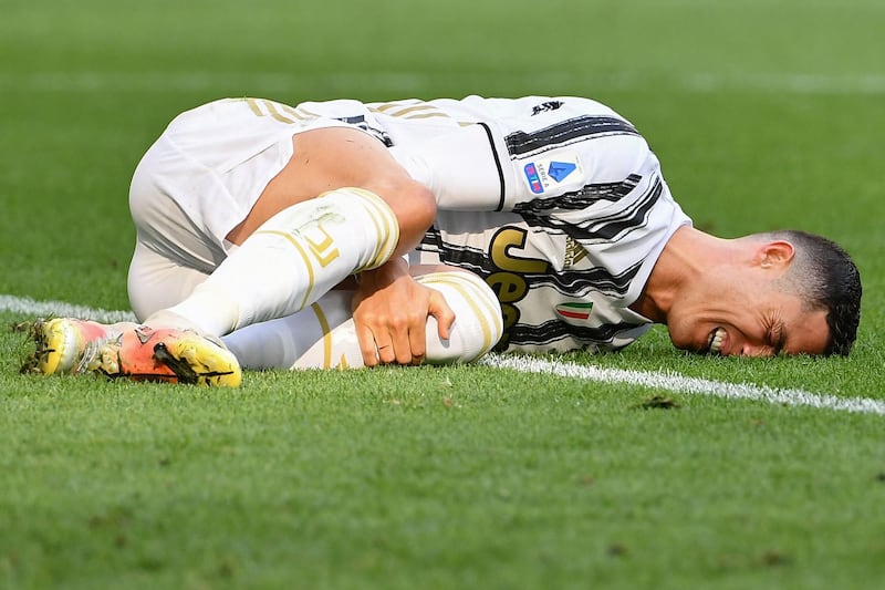 Cristiano Ronaldo goes down injured during the game. AFP