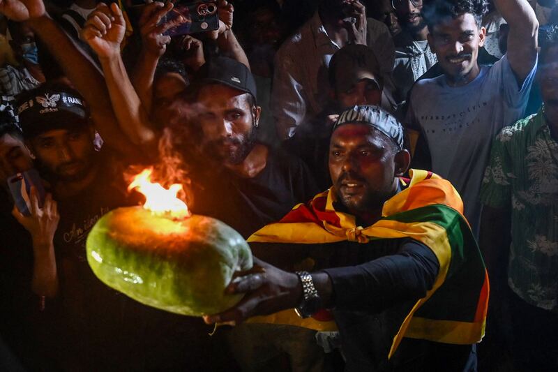 Sri Lankan demonstrators take part in a celebration in Colombo to mark the 100th day of protests. AFP