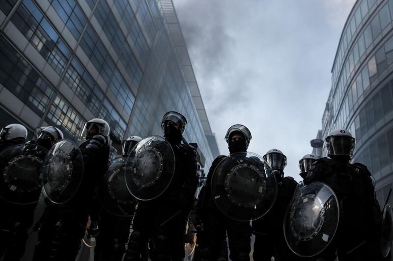 Anti-riot policemen face protesters during clashes as part of a demonstration near major EU buildings in Brussels, Belgium. AFP