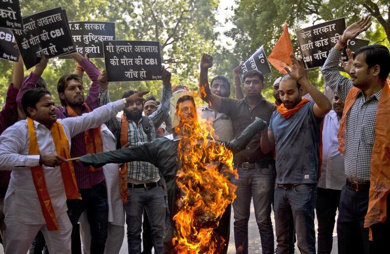 Right-wing Hindu activists burn an effigy of the Uttar Pradesh state chief minister, Akhilesh Yadav, yesterday in New Delhi demanding investigation by a central government agency into their claim that the farmworker lynched by a mob in a village near the capital had stored beef in his house. The inquiry by the regional government had ruled out that the farmer had a stock of beef. Saurabh Das / AP Photo
