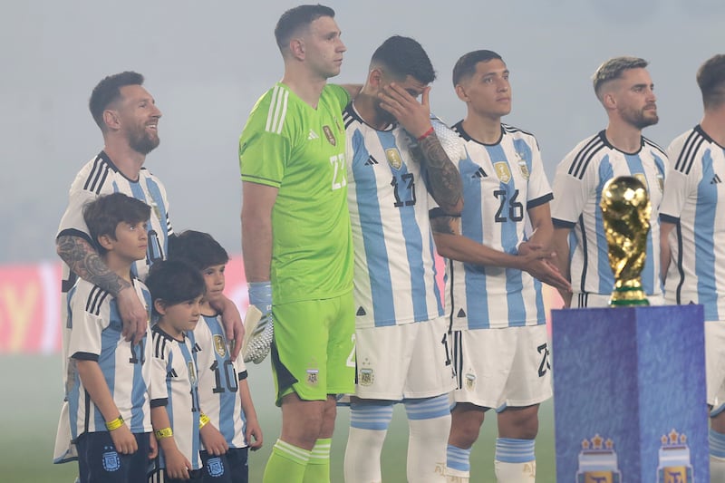 Lionel Messi of Argentina with his children and teammates line up for the national anthem. Getty Images