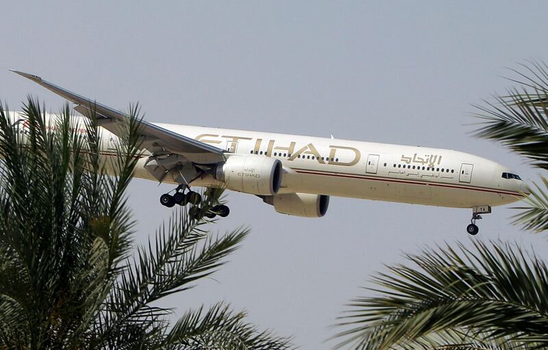 FILE- In this Sunday, May 4, 2014 file photo, an Etihad Airways plane prepares to land in Abu Dhabi Airport, United Arab Emirates. The United Arab Emirates' national airline says it is working with Australian police in its investigation into an attempted airplane attack. (AP Photo/Kamran Jebreili, File)