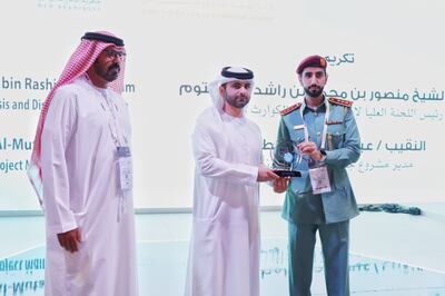 Sheikh Mansoor bin Mohammed honoured Captain Essa Al Mutawa from Dubai Civil Defence for using data analysis to reduce fire risks. Lt Gen Rashid Al Matrooshi is pictured (left). Photo: Dubai Civil Defence.