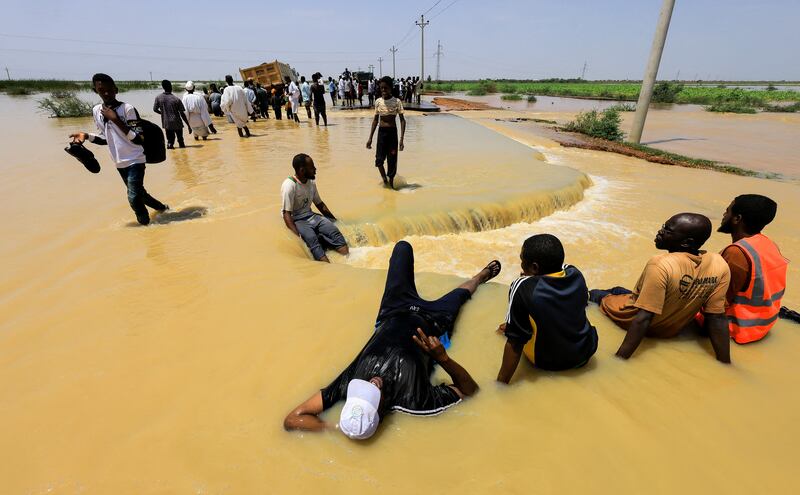 Taking a rest during floods in Al Manaqil. Reuters