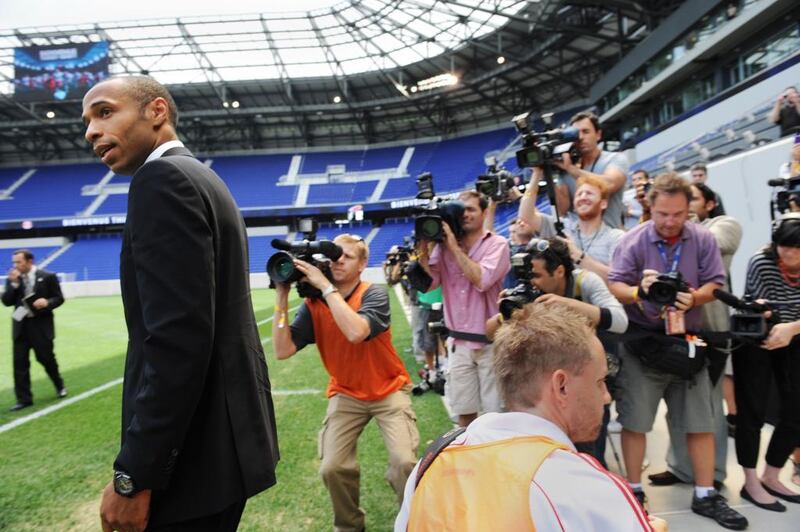 Thierry Henry walks past photographers at a press conference for his introduction with MLS club New York Red Bulls on July 15, 2010 in New Jersey, USA. Stan Honda / AFP