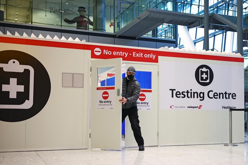 A man opens the door of a testing cente at Heathrow Airport. Reuters