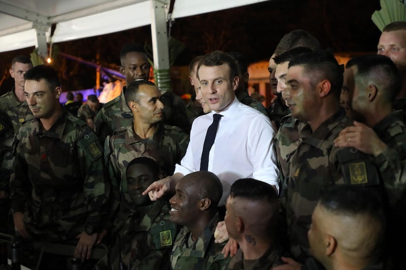 French President Emmanuel Macron speaks with French soldiers during Christmas diner with the troops at the Port-Bouet military camp near Abidjan on December 20, 2019, on the first day of his three day visit to West Africa.
  / AFP / Ludovic MARIN
