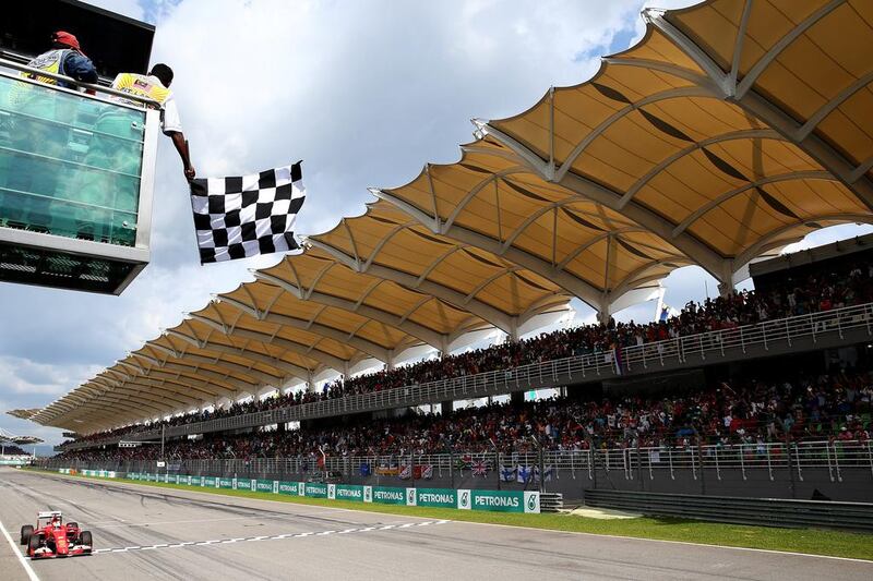 Vettel crosses the finish line and takes the Malaysian Grand Prix checkered flag. Mark Thompson / Getty Images