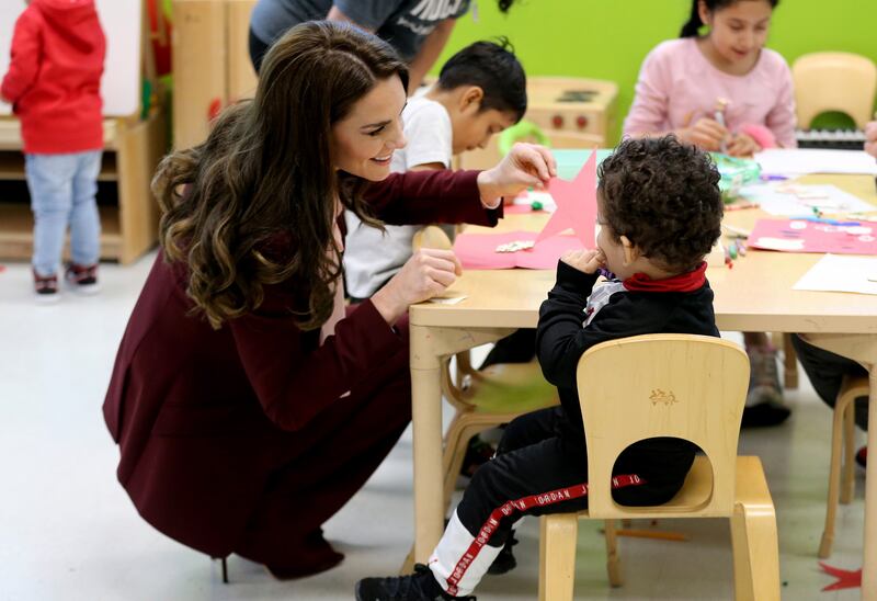 Kate with children at Roca. EPA