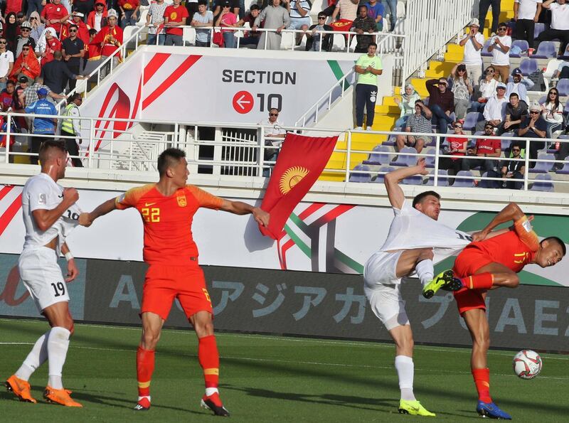 China's midfielder Zhang Chengdong fights for the ball with Kyrgyzstan's forward Mirlan Murzaev. AFP