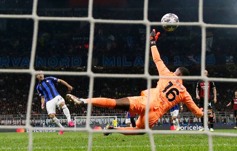 Inter Milan's Henrikh Mkhitaryan scores their second goal past AC Milan's Mike Maignan. Reuters