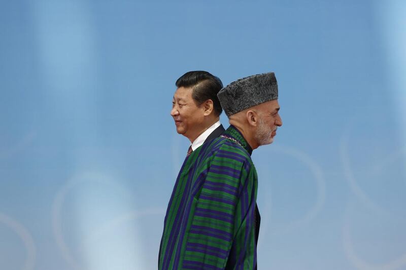 Afghan President Hamid Karzai, right,  walks away after shaking hands with Chinese President Xi Jinping before the opening ceremony in the Expo Center at the fourth Conference on Interaction and Confidence Building Measures in Asia (CICA) summit in Shanghai. Aly Song / AP