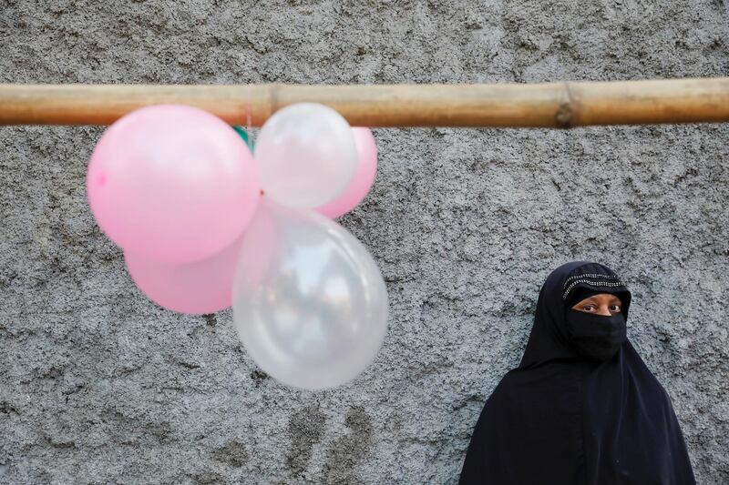 A woman stands under balloons decorating an alley near the Holy Rosary church before Pope Francis arrives there, in Dhaka, Bangladesh. Damir Sagolj / Reuters