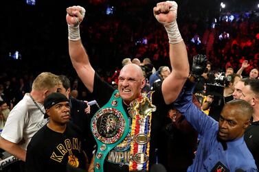 Boxing - Deontay Wilder v Tyson Fury - WBC Heavyweight Title - The Grand Garden Arena at MGM Grand, Las Vegas, United States - February 22, 2020 Tyson Fury celebrates with the belts after winning the fight against Deontay Wilder as referee Kenny Bayless looks on REUTERS/Steve Marcus