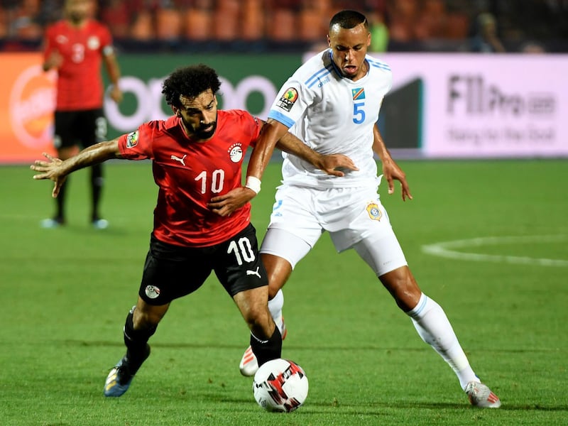 Egypt forward Mohamed Salah, left, fights for the ball with DR Congo's Marcel Tisserand. AFP